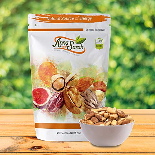 Raw Brazil Nuts unsalted on wooden ground in resealable pack with small bowl brazil nuts inside with green background by Anna and Sarah